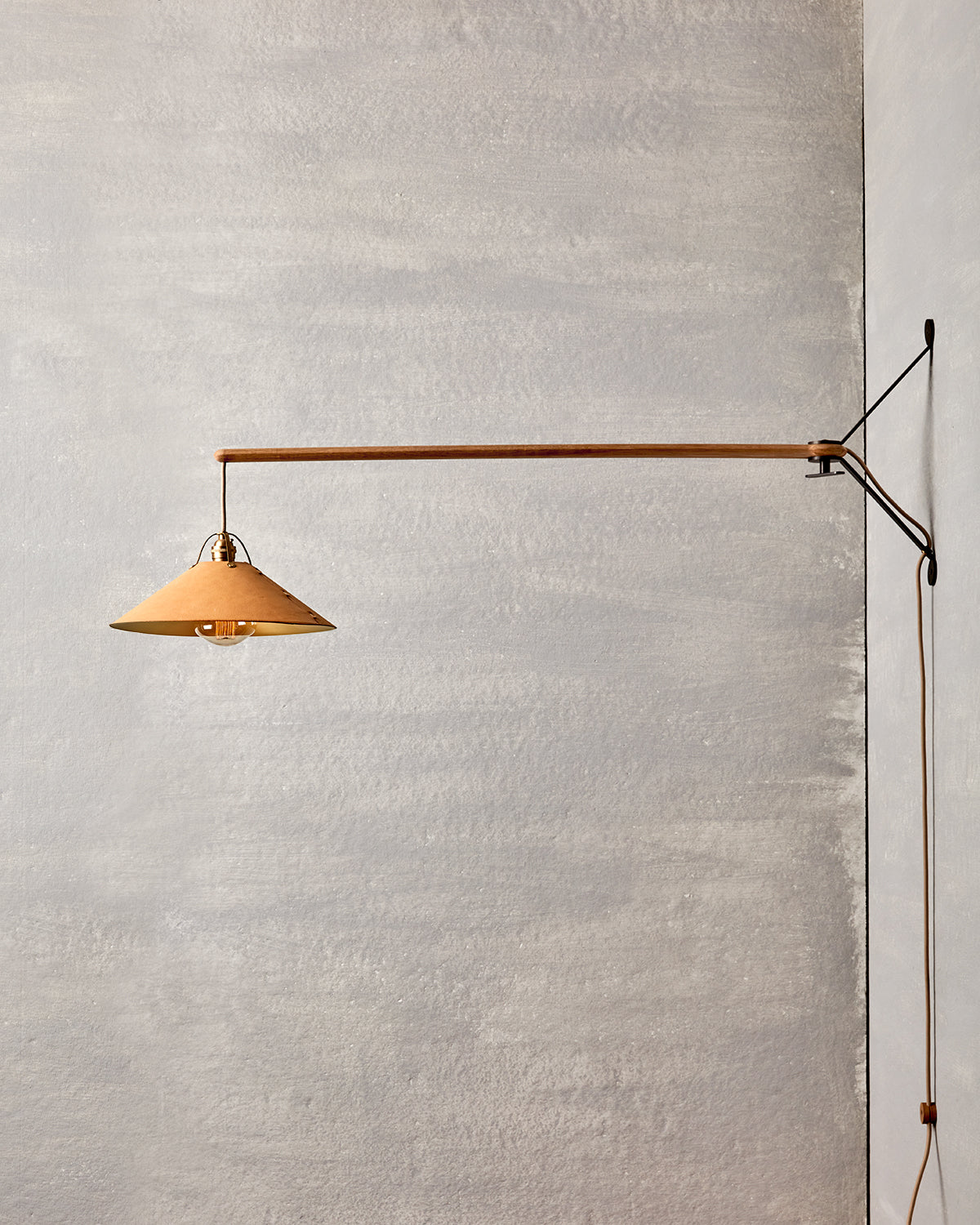 Wooden swing arm sconce with Luxurious handmade leather and brushed satin brass shade