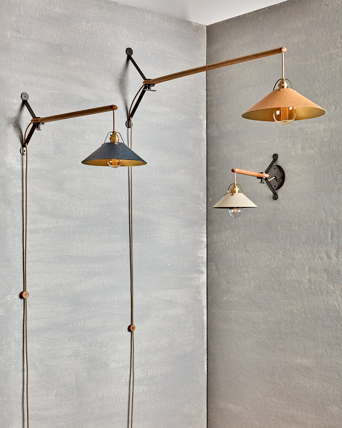 Wooden swing arm sconce with Luxurious handmade leather and brushed satin brass shade