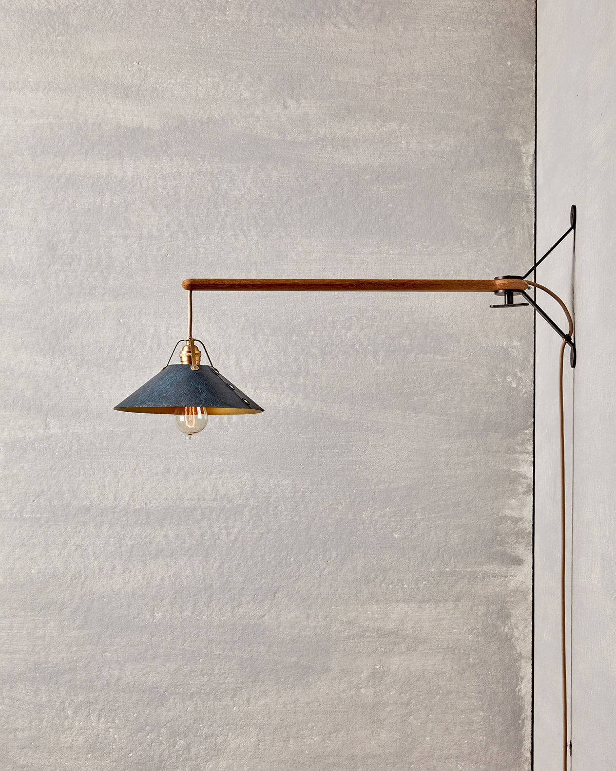 Wooden swing arm sconce with Luxurious handmade leather and brushed satin brass shade