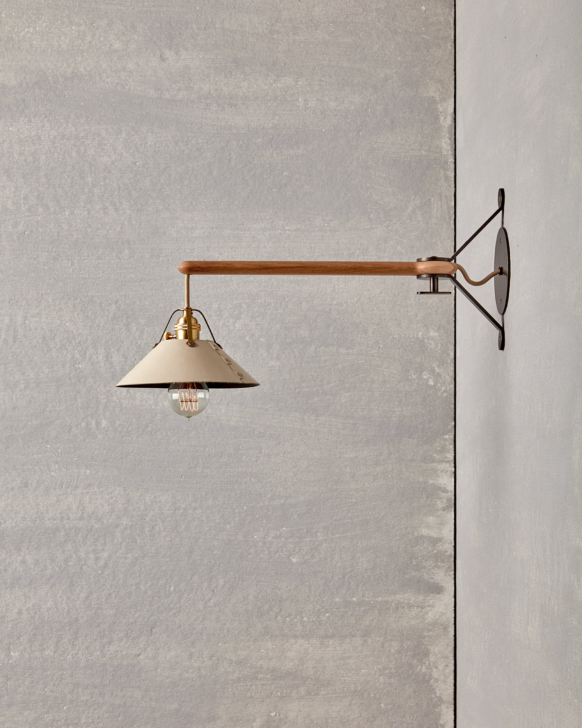 Wooden swing arm sconce with Luxurious handmade leather and brushed satin brass shade