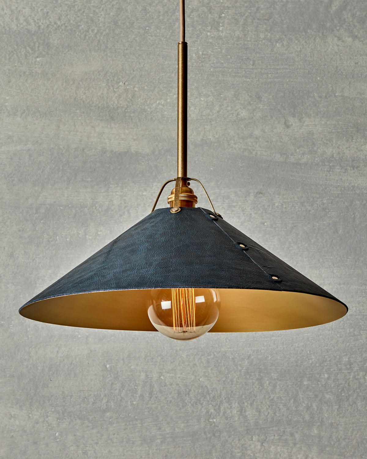 Navy blue leather and satin brass ceiling pendant light. Made by RTO Lighting in Philadelphia. Hardwired light fixture. Simple interior design, made in the USA.