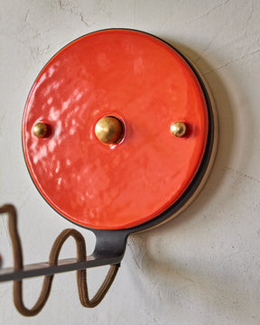 Maple, steel and ceramic wall sconce with articulating arm with glossy red orange stoneware shade and backplate