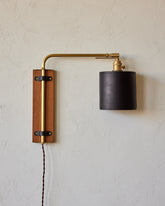 Sophisticated walnut, brass and leather plug in wall sconce with articulating arm and shade
