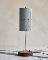 Charming accent lamp with blue leather, warm brass and walnut wood