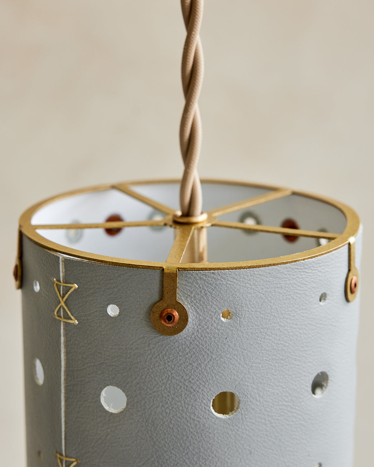 Charming leather pendant light with blue handstitched shade and brass accents