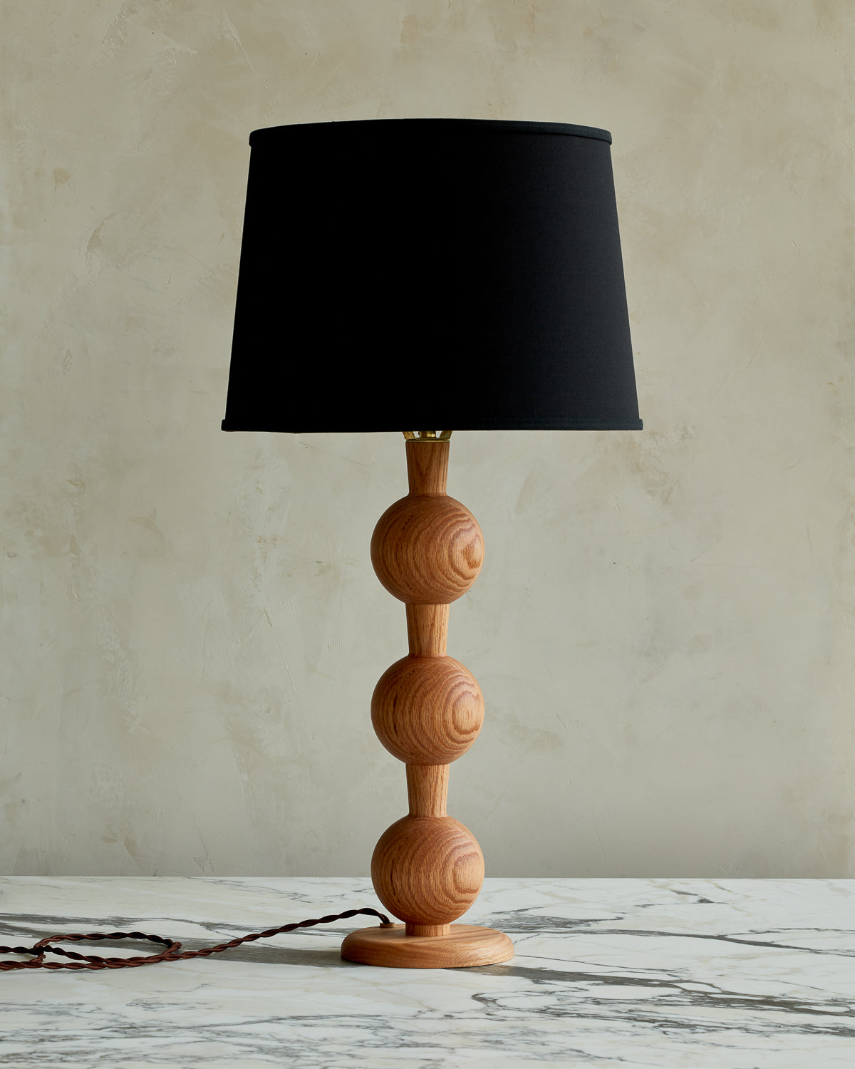 Sculptural solid wood table lamp with barbell design in natural finish with black linen shade #wood-finish_natural red oak #shade-color_black linen