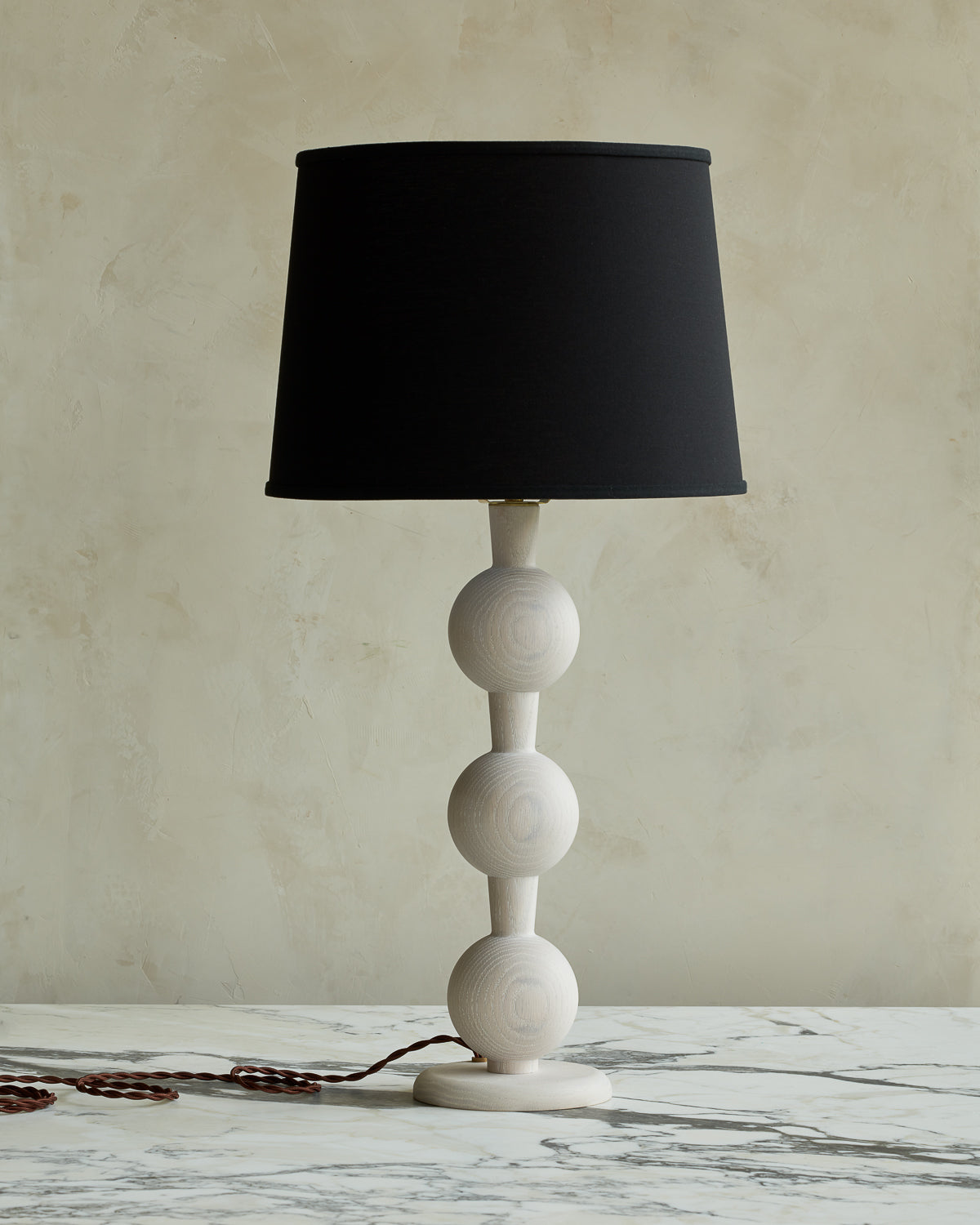 Sculptural solid wood table lamp with barbell design in white wash finish with black linen shade #wood-finish_white wash red oak #shade-color_black linen