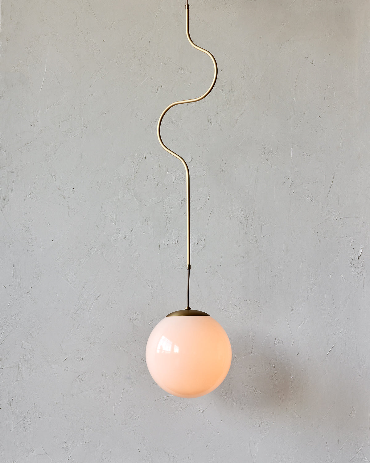 Modern brass globe pendant light with warm satin brass curved body and white milk glass globe #metal-finish_satin brass #size_large