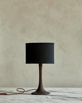 Small Trumpet table lamp with dark wash finish and black drum shade