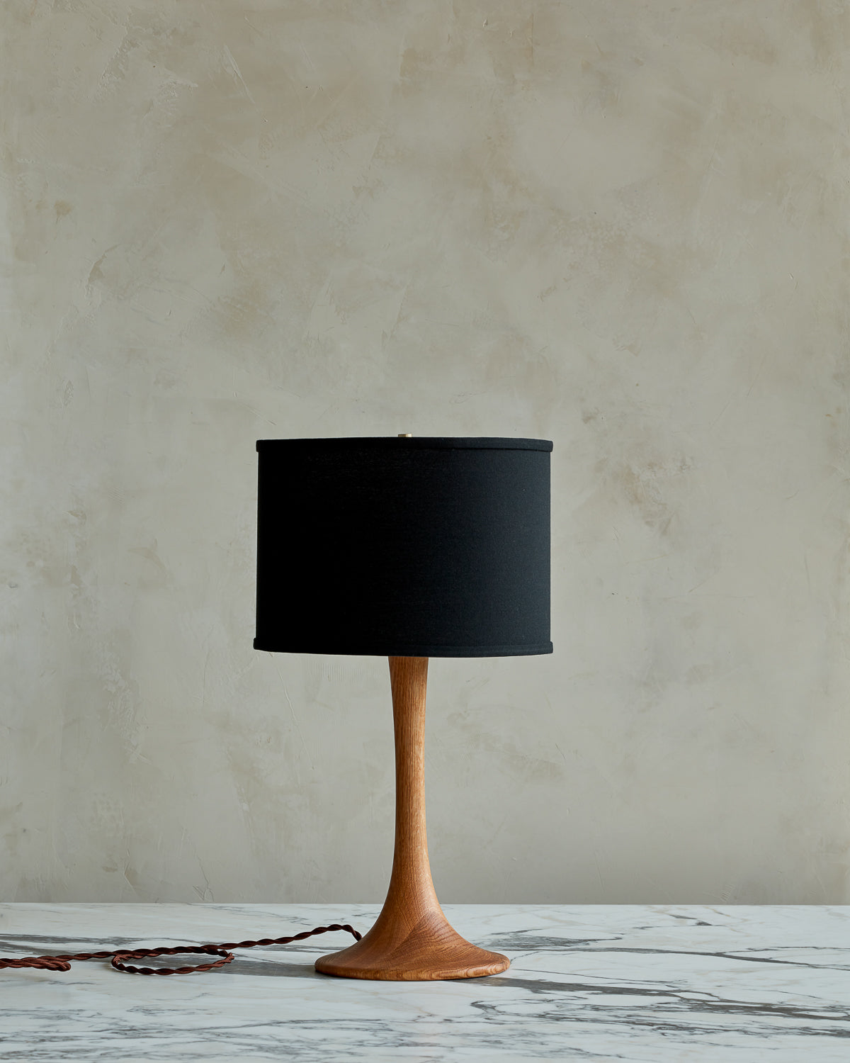 Small Trumpet table lamp with natural finish and black drum shade