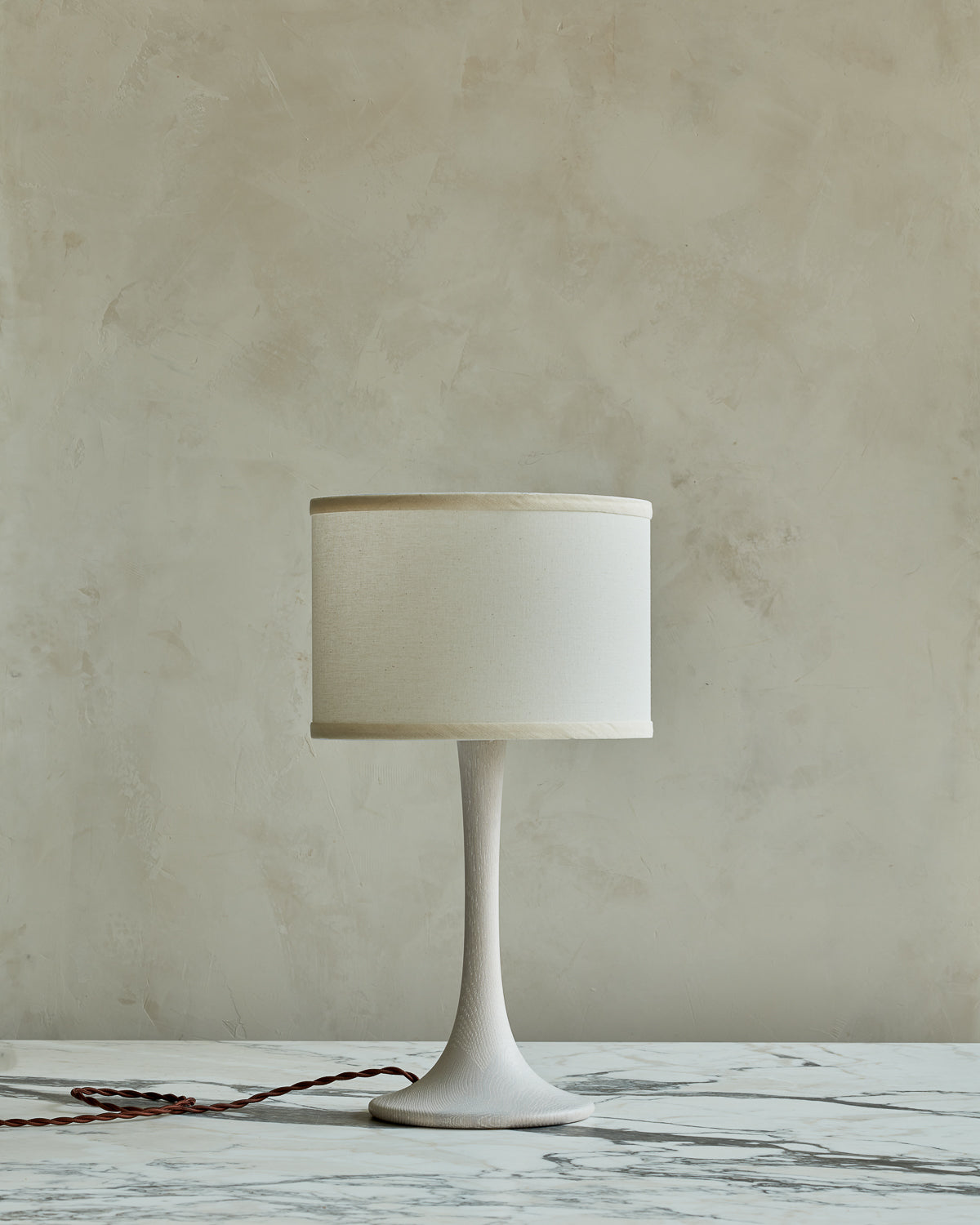 Small Trumpet table lamp with white wash finish and ivory drum shade