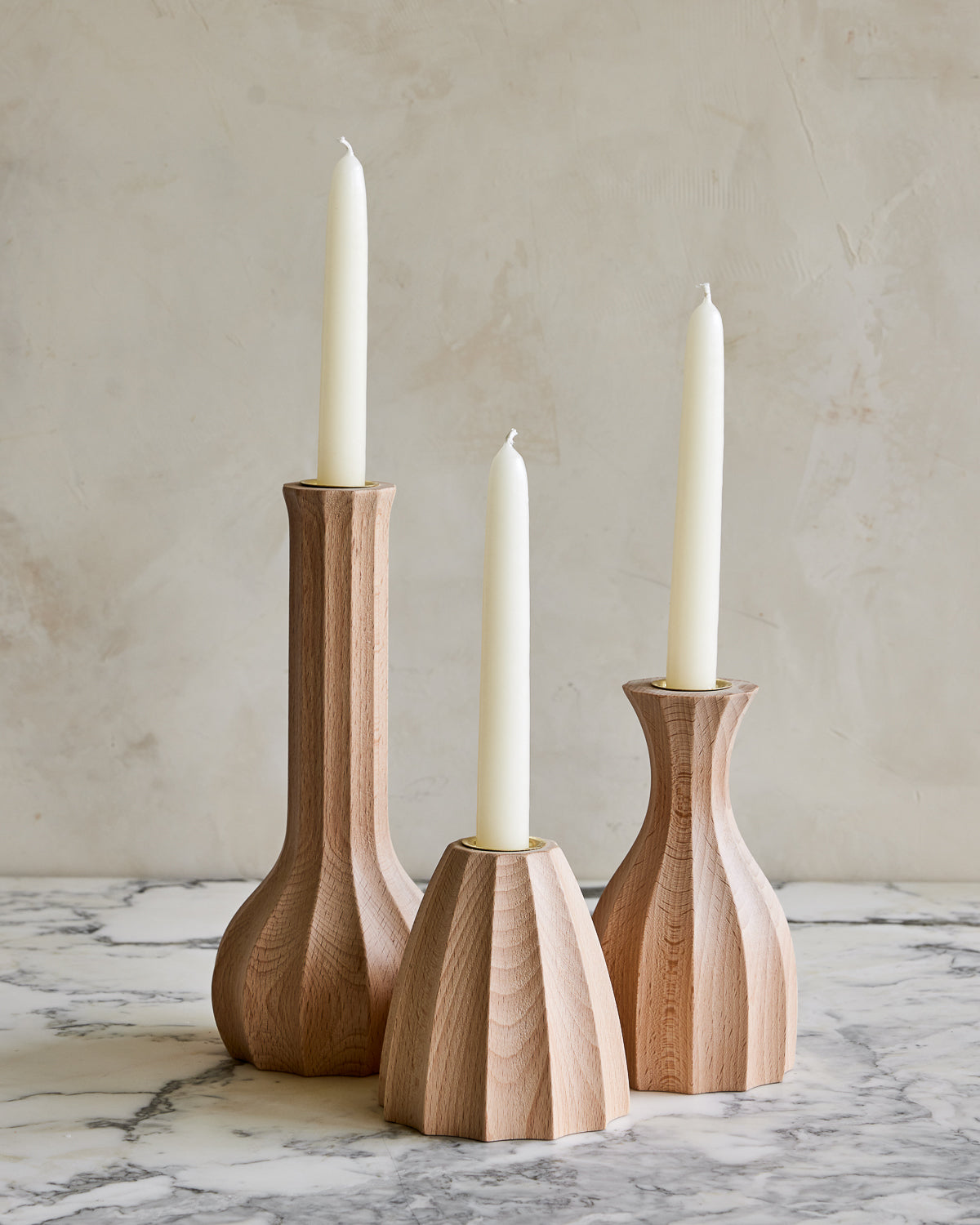 Trio of natural maple wooden candle holders with delicate grooves