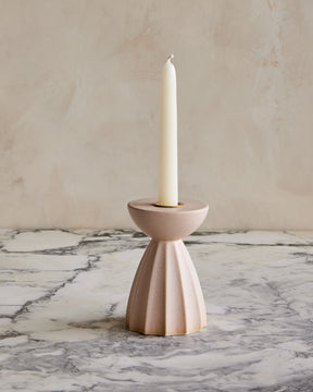 Blush Sabine ceramic candle holder with fluted ridged base in matte pink glaze with white taper candle