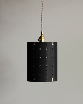 Black leather cylinder pendant with handstitched, perforated leather shade. Made by Lostine in Philadelphia. Hardwired or plug light fixture. Simple interior design, made in the USA.