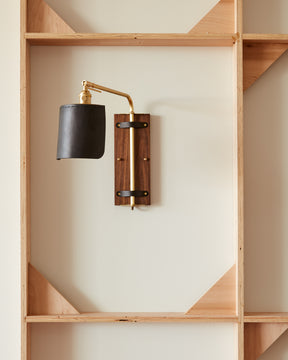 Sophisticated walnut, brass and leather hardwired wall sconce with articulating arm and shade