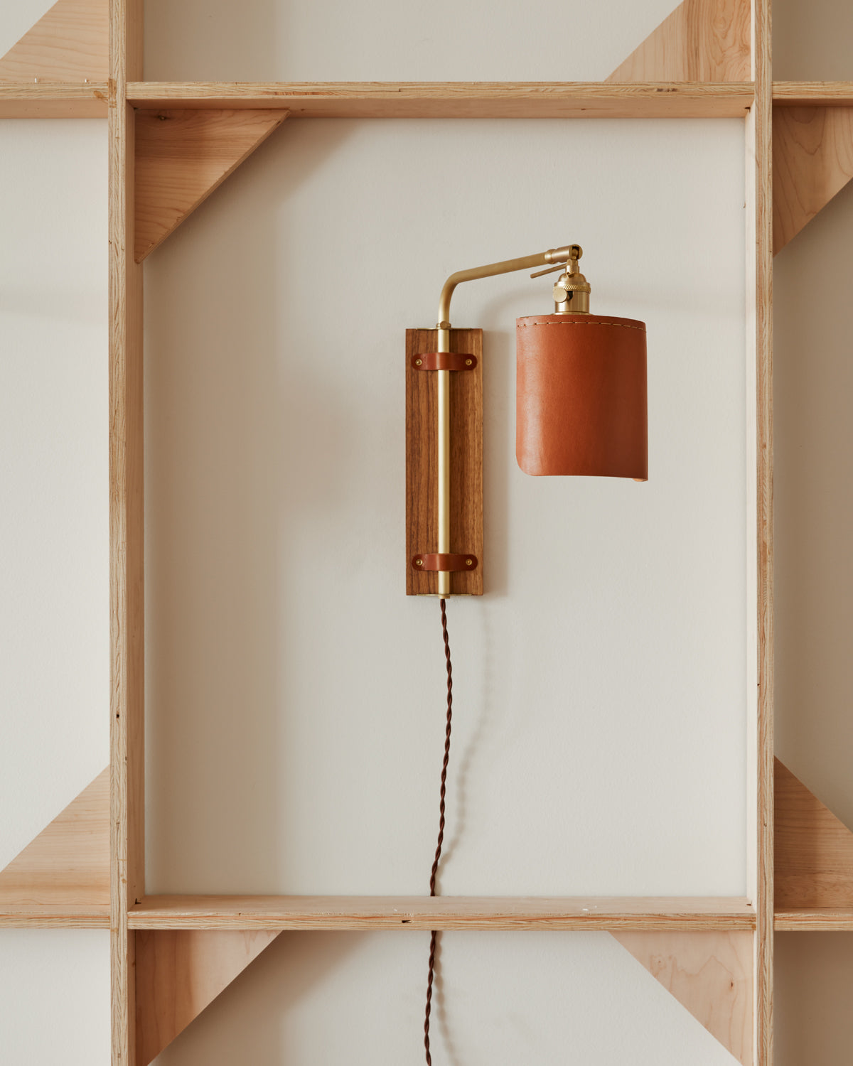 Sophisticated walnut, brass and leather plug in wall sconce with articulating arm and shade