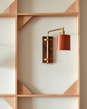 Sophisticated walnut, brass and leather hardwired wall sconce with articulating arm and shade