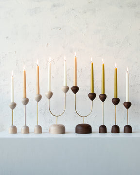 Collection of maple and walnut modern candle holders with brass accents
