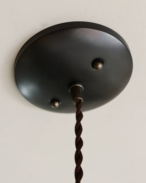 Black leather cylinder pendant with handstitched, perforated leather shade. Made by Lostine in Philadelphia. Hardwired or plug light fixture. Simple interior design, made in the USA.