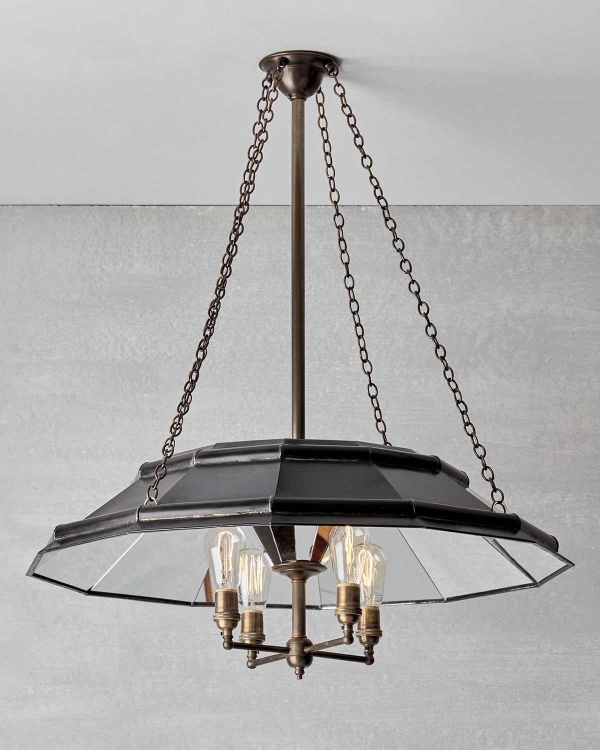 Victorian style metal chandelier with mirrored interior and edison bulbs
