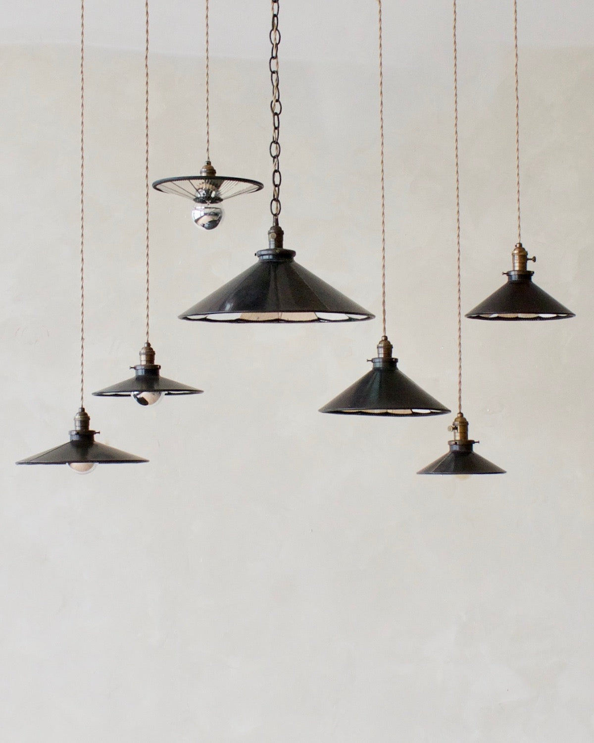 Modern mirrored cone pendants with oil rubbed brass. Hardwired light fixture. Simple interior design, made in the USA.