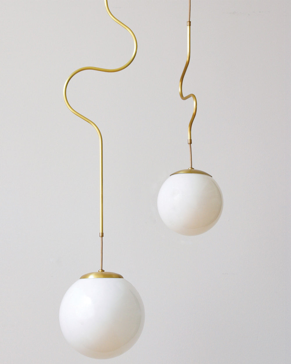 Satin brass Contour ceiling pendant lights made by Lostine in Philadelphia, Pennsylvania. Satin brass modern lighting design with white glass globe. Hardwired light fixture. Simple interior design, made in the USA. #metal-finish_satin brass 